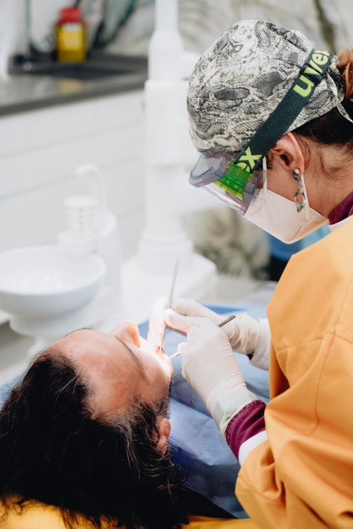 A dentist performs a dental procedure on a patient in a modern clinic setting.
