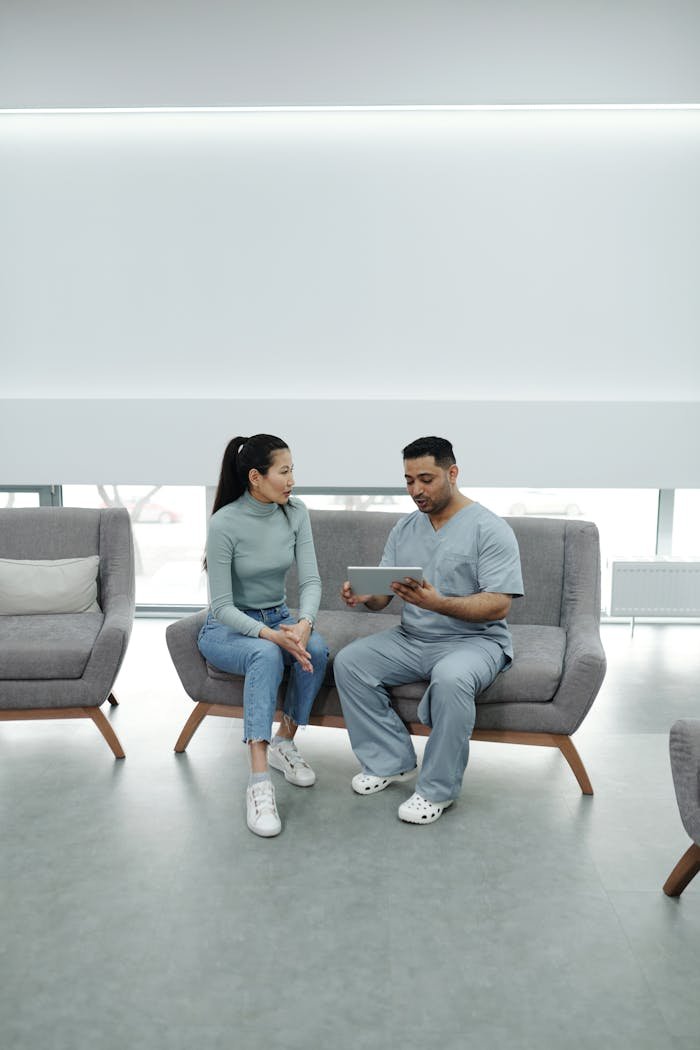 home-hero Doctor consulting a patient using a tablet in a modern clinical setting